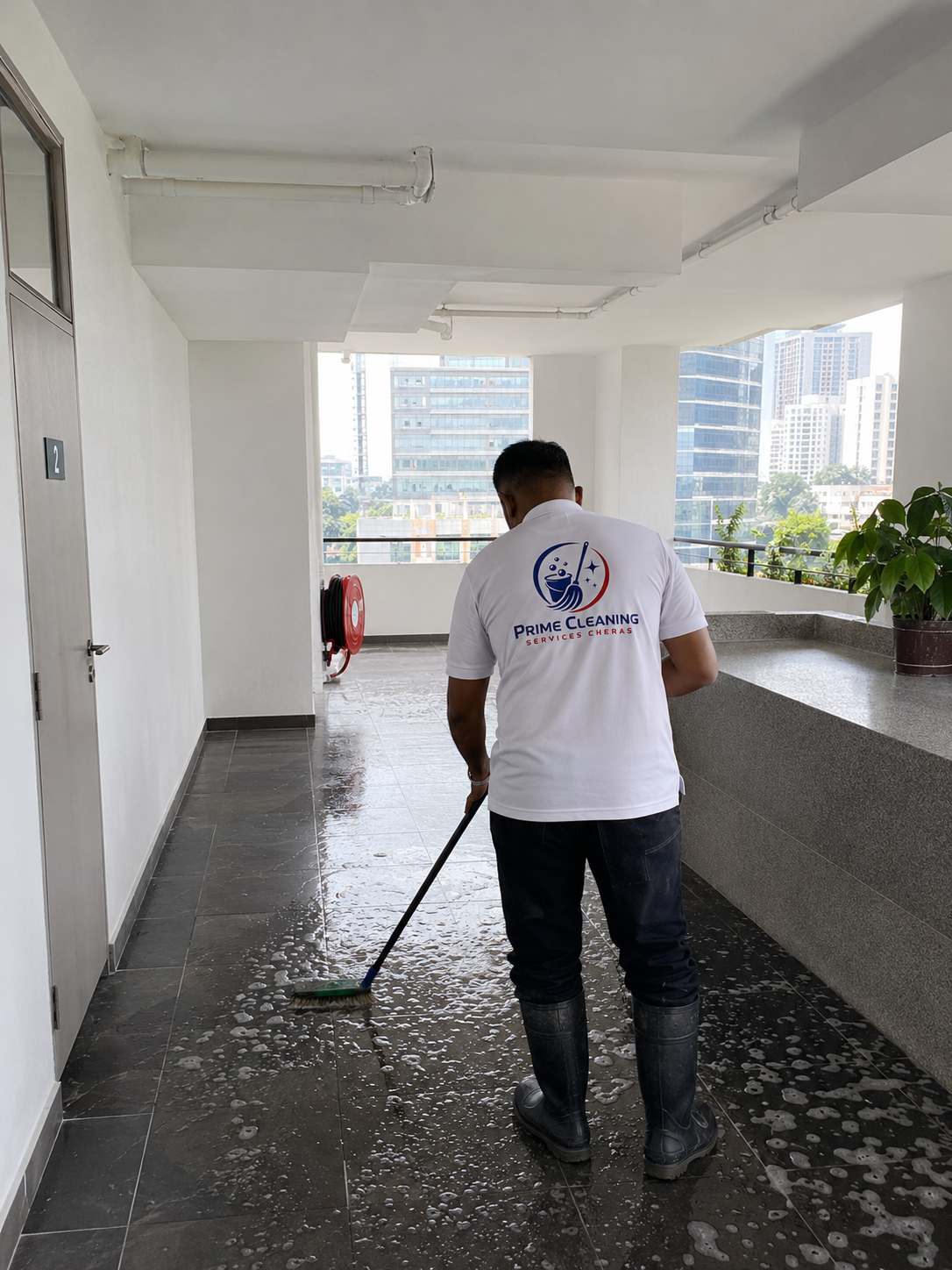 Prime cleaner working in a Cheras high-rise common corridor