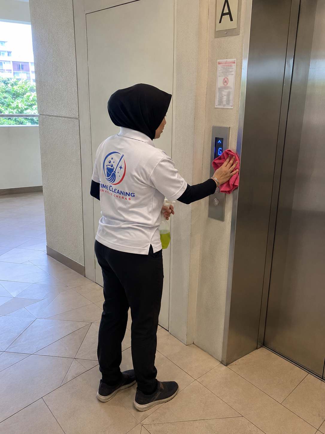Prime cleaner sanitising a lift panel in a Cheras building